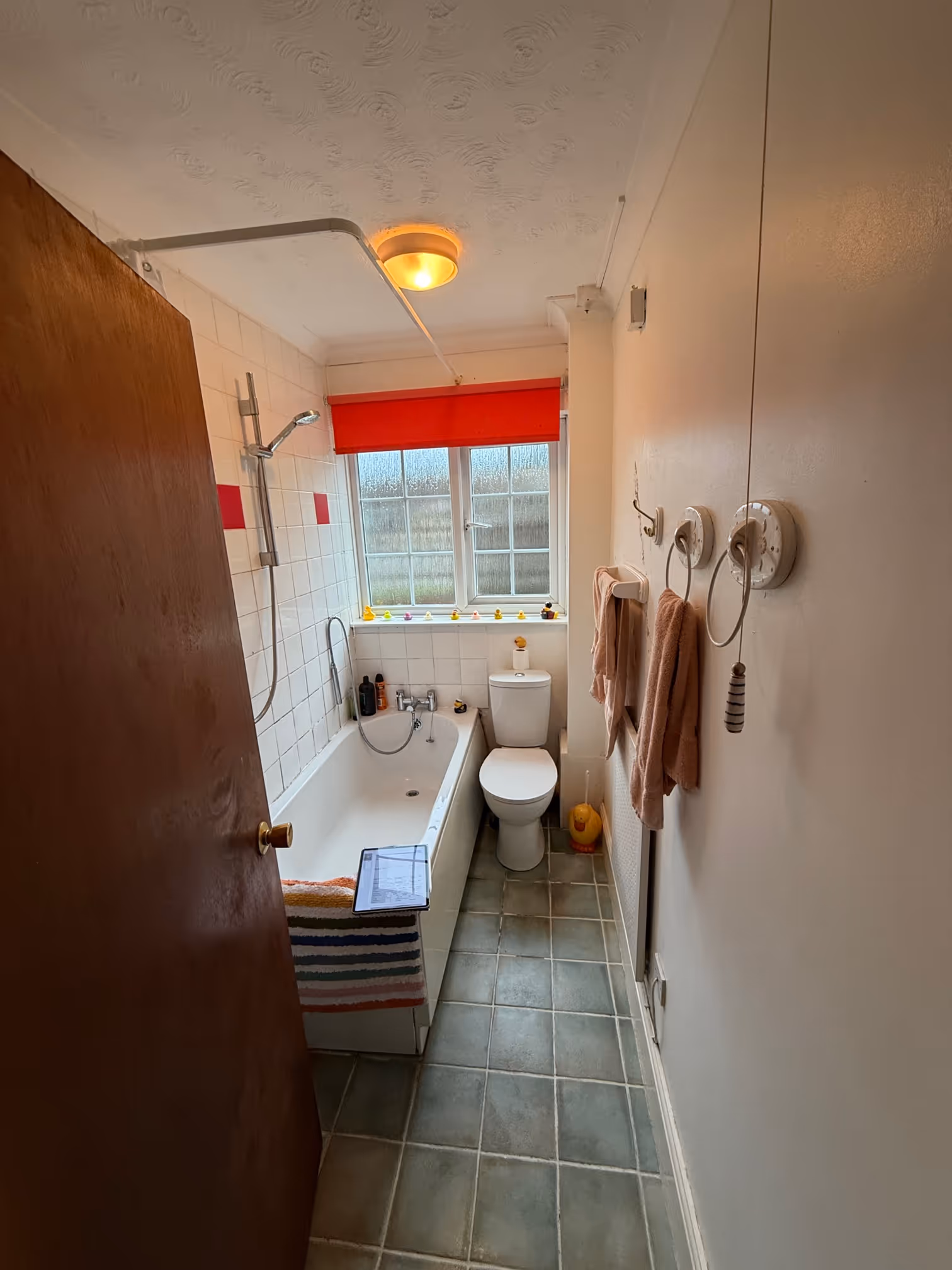 Bathroom before renovation showing original suite, wall tiles, and layout prior to refurbishment by DSB Bathrooms in Devon.