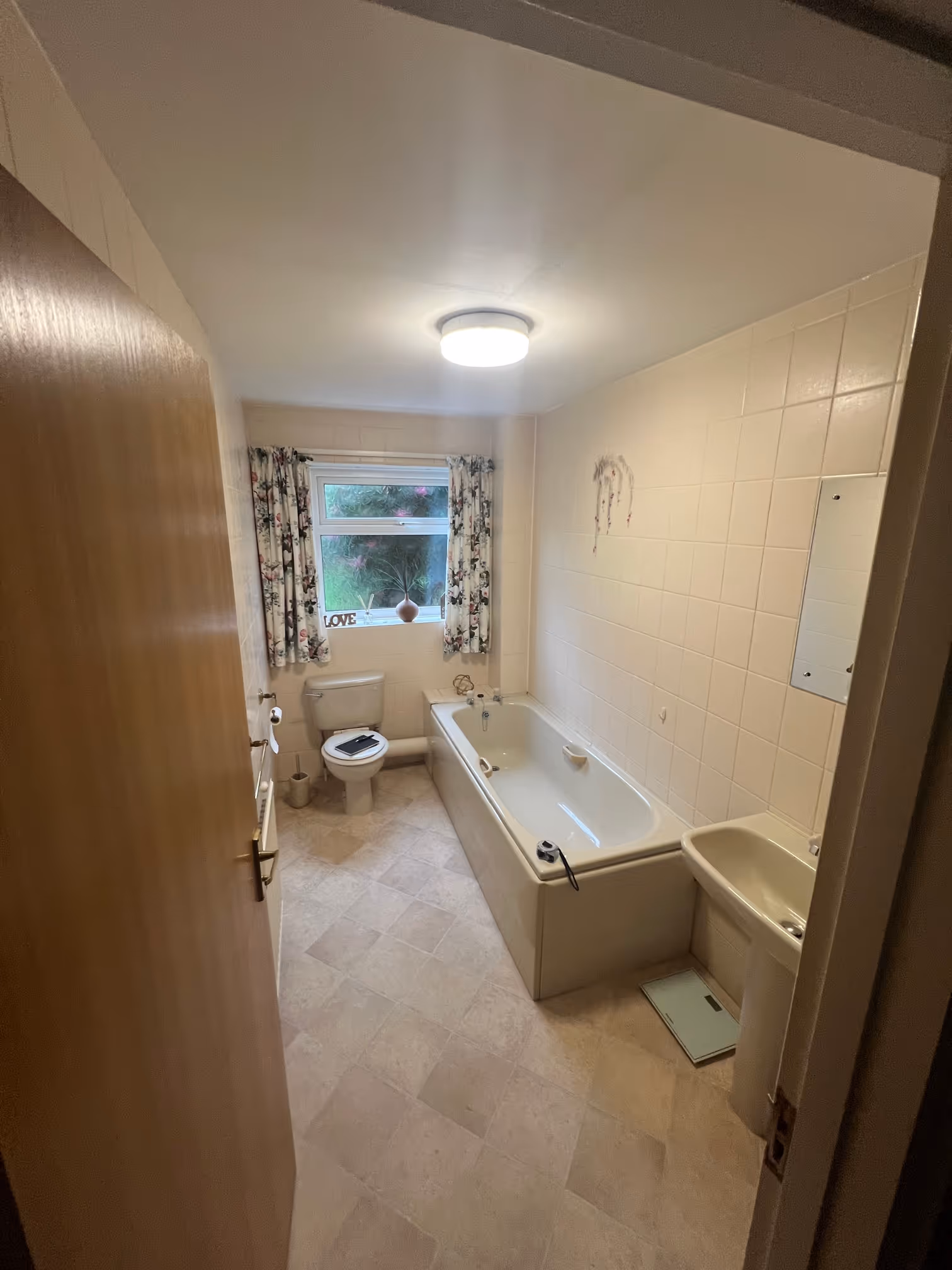 Modern bathroom renovation in Exeter with walk-in shower, chrome fittings, and waterproof wall panels.