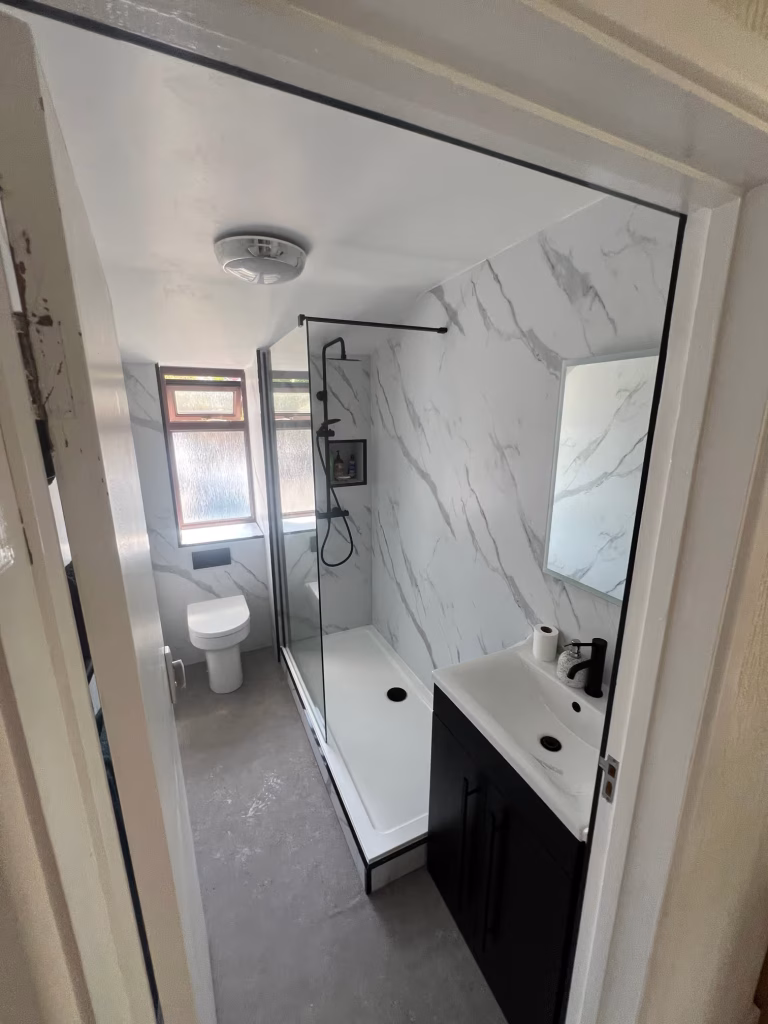 Modern bathroom renovation in Teignmouth with walk-in shower and matt black fixtures