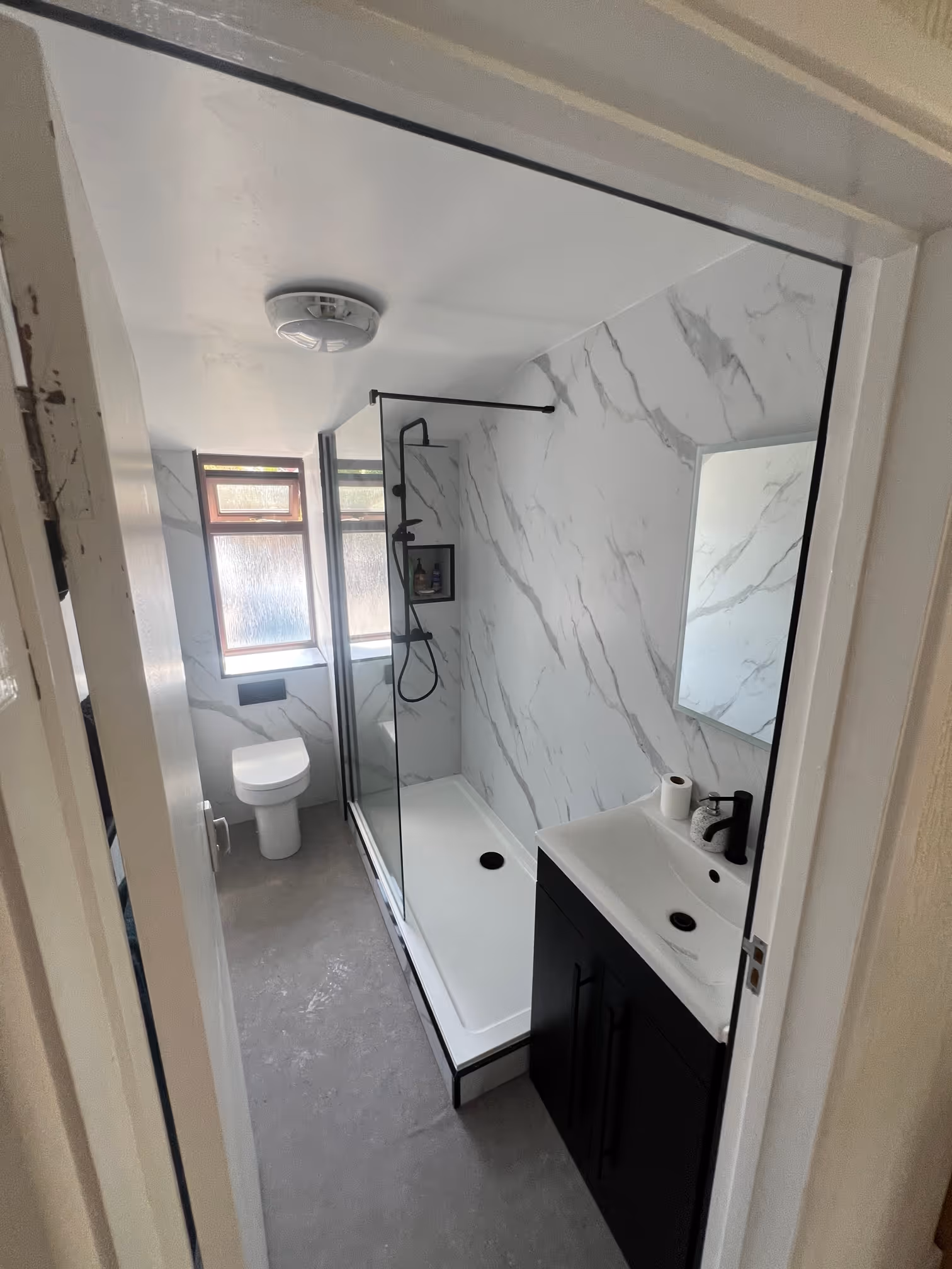 Modern bathroom renovation in Teignmouth with walk-in shower and matt black fixtures